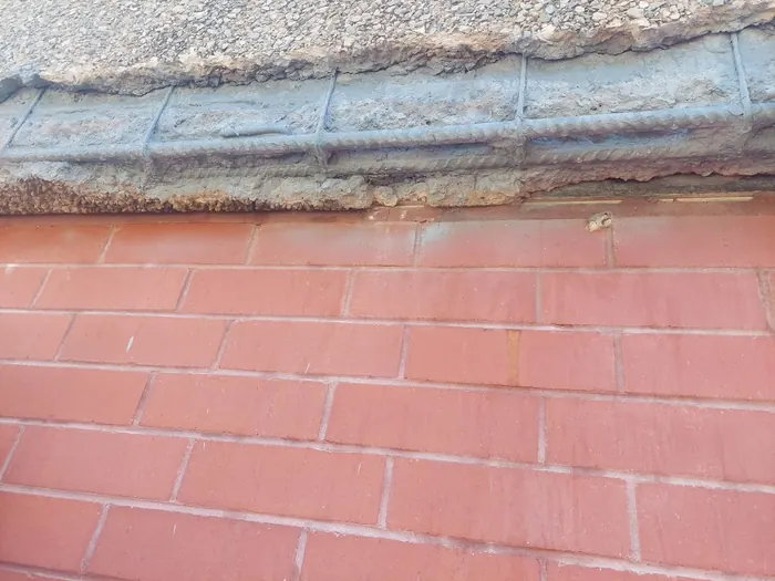 Reinforcement exposed and treated with rust-inhibiting primer