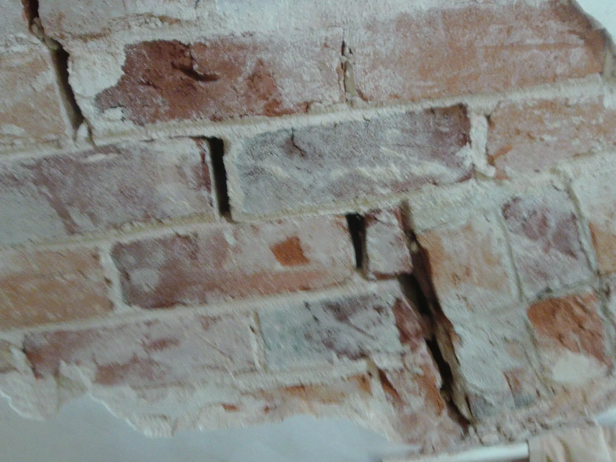 Cracked brickwork being repaired with Helifix stainless steel crack stitching bars