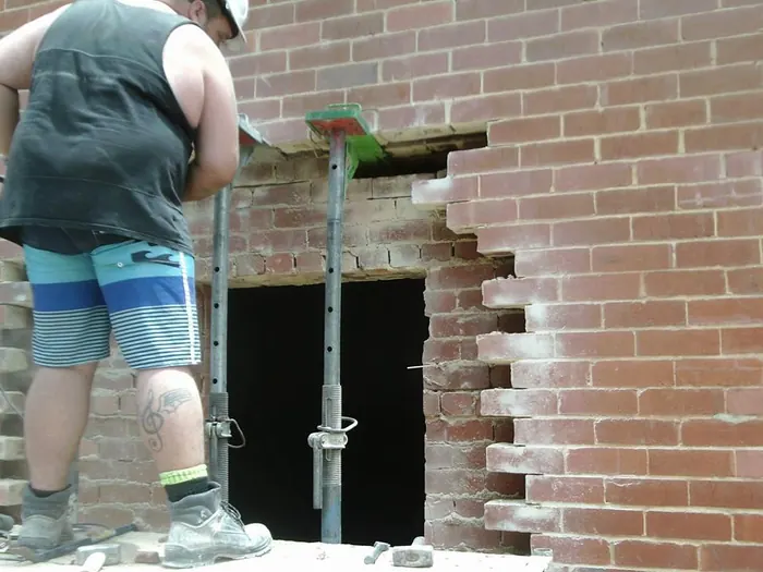 Creating a new door opening in the facade