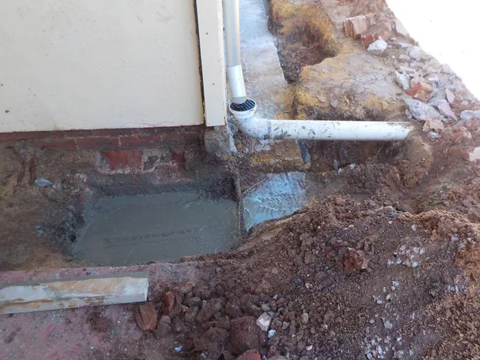 Underpinning the footing beneath